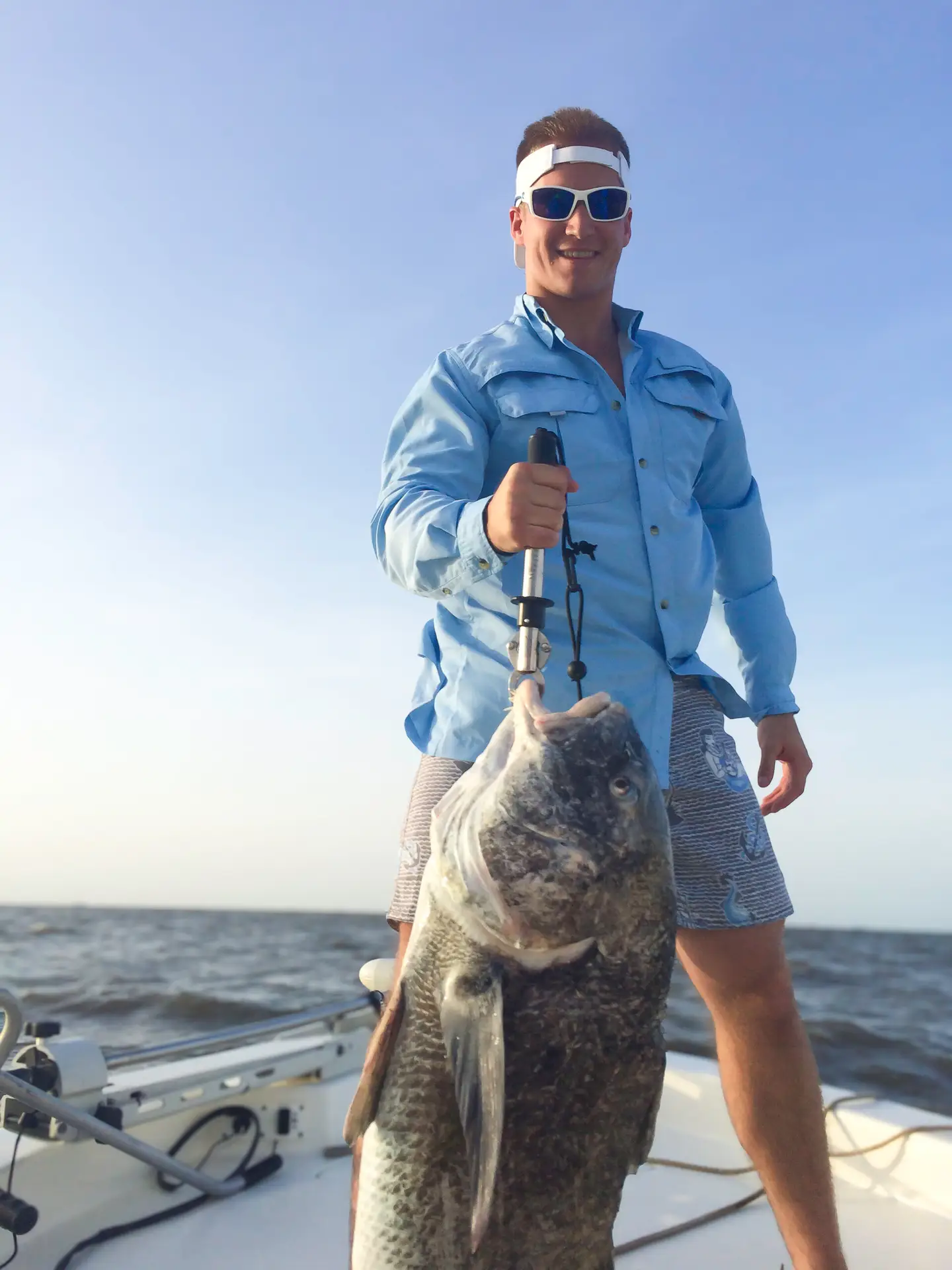 Men Holding Fish in Hook